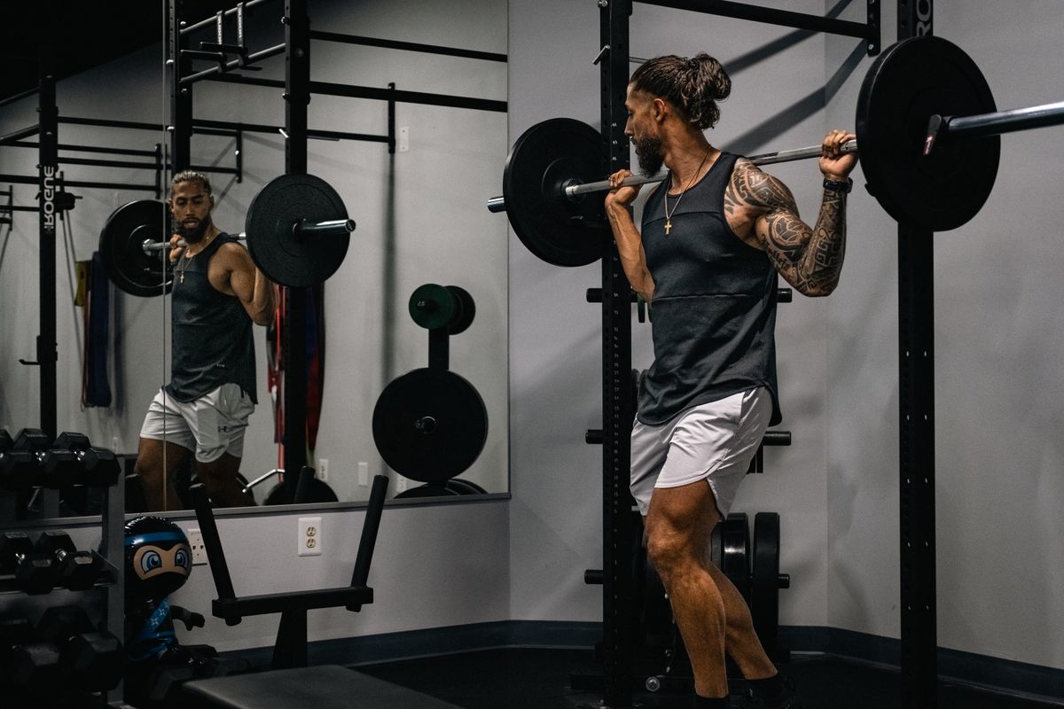 Return to the gym after a long break: a four-week plan | the gym pro Lifter Squatting Inside A Rack