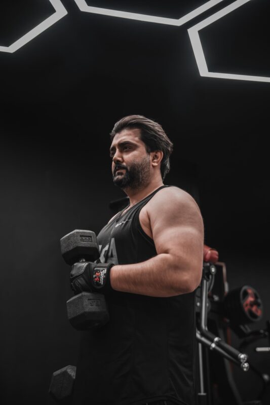 Sets per muscle per week: count and adjust your volume | the gym pro Man Holding Dumbbells In A Gym