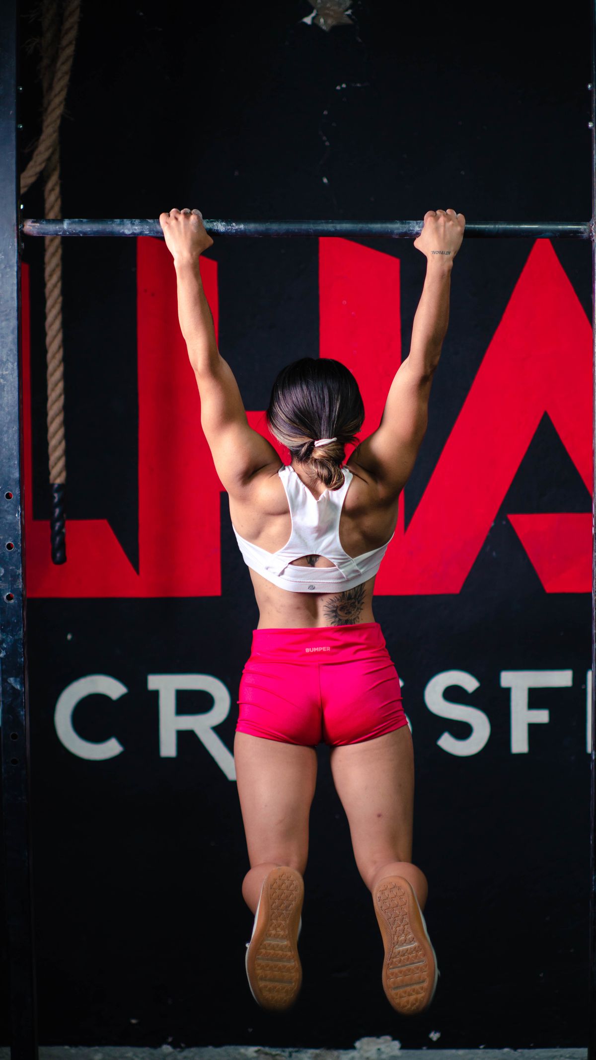 How to get your first pull-up: an 8-week practice plan | the gym pro Athlete Hanging From A Pull-Up Bar