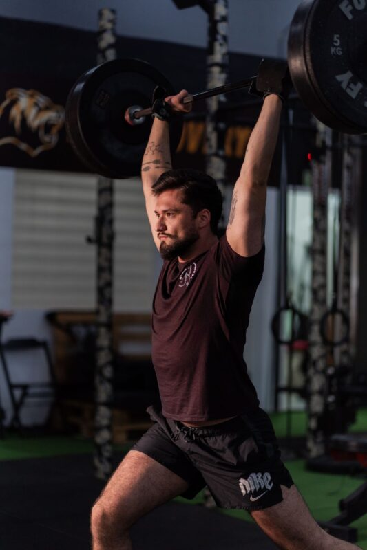 Dumbbell-only workout plan: three days to build muscle | the gym pro Lifter Holding A Barbell Overhead