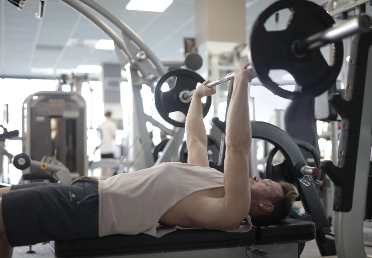 Improve your bench press: setup and a two-day plan | the gym pro Lifter Performing A Barbell Bench Press