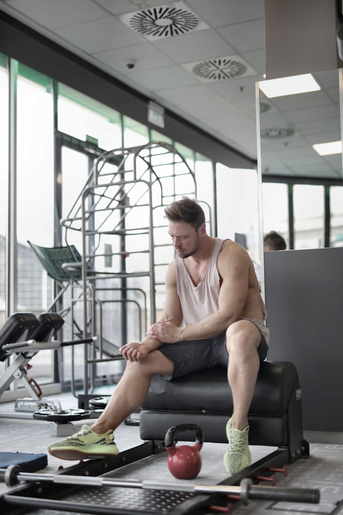 Rest between sets: a practical guide for muscle growth | the gym pro Man Resting On A Bench Between Exercises