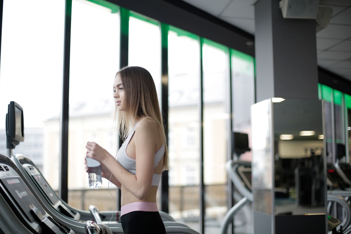 How to wash gym clothes and remove persistent sweat smells | the gym pro Woman Holding A Drink Beside A Treadmill
