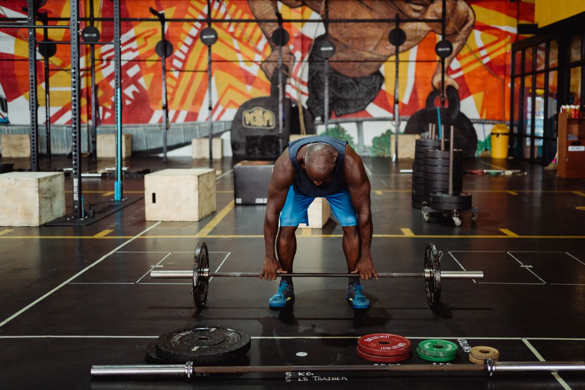 Creatine for muscle growth: dose, loading and expectations | the gym pro Man Preparing A Barbell In A Gym