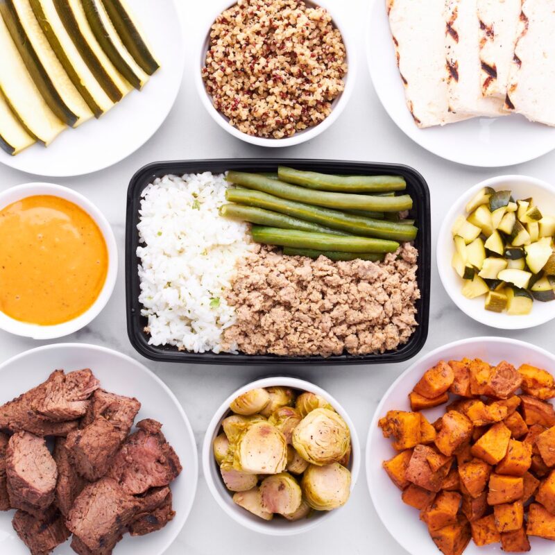 Protein for muscle growth: daily targets and meal examples | the gym pro Protein Foods, Grains And Vegetables Arranged In Meal Containers