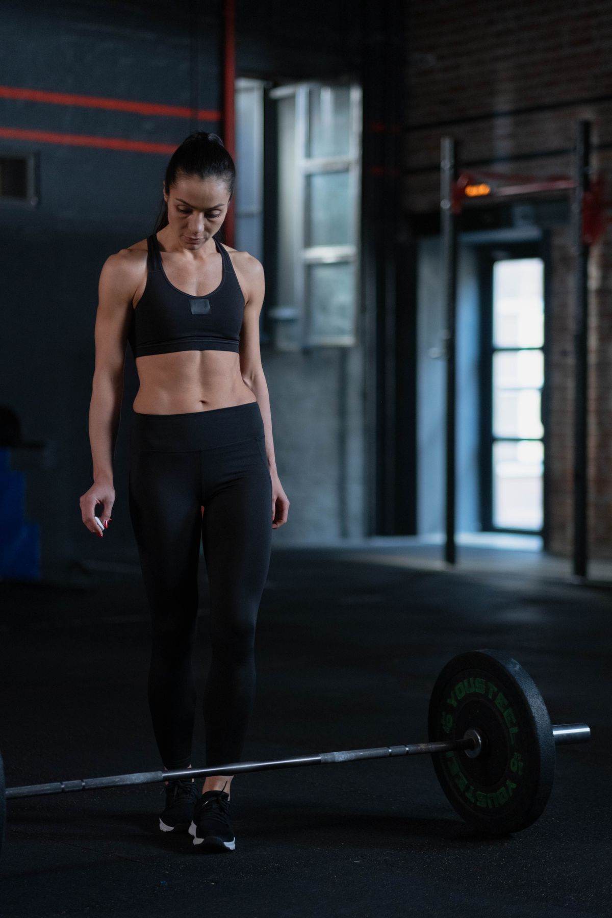 Best gym clothes for weightlifting: fit and fabric guide | the gym pro Woman Standing Beside A Barbell In A Gym